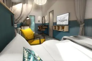 S-Studio Room with yellow chair and television.