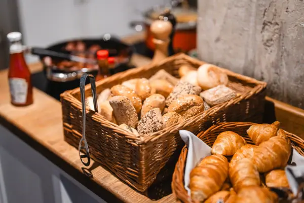 Bread roll basket on the buffet Baskets of bread and croissants on a counter