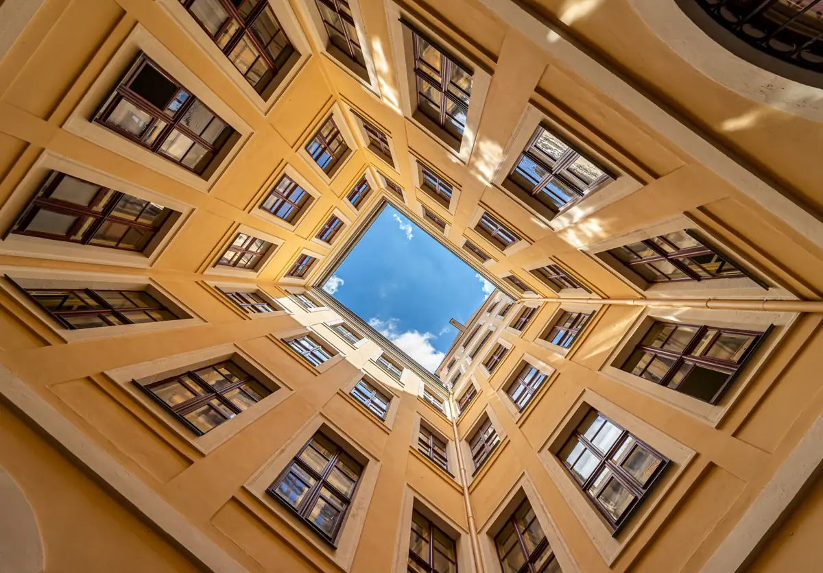 Inner courtyard The view from an inner courtyard up to the blue sky with symmetrical windows.