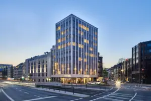 HENRI Hotel Düsseldorf A well-lit commercial building in an urban area at night.