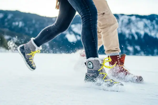 Winter hiking in Garmisch-Partenkirchen A pair of feet in snow boots on snow.