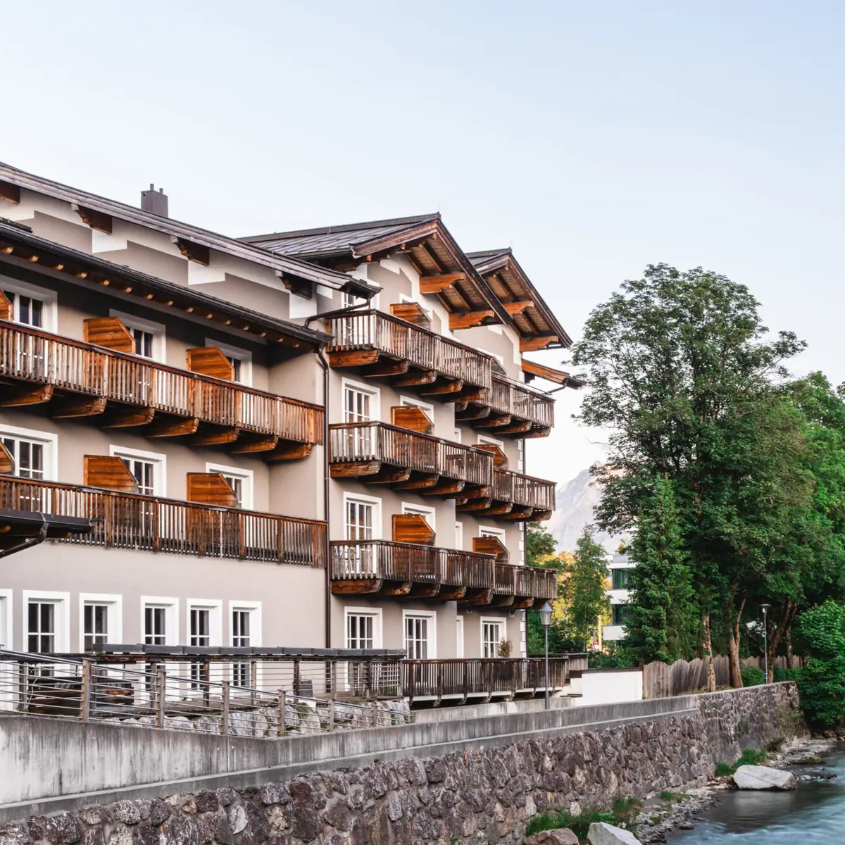 HENRI Hotel Kitzbühel on the Tiroler Ache A building next to a river.