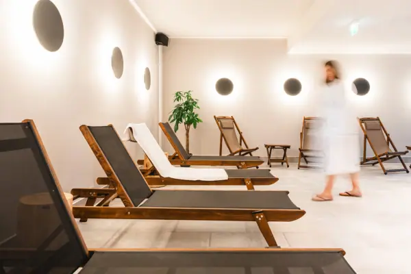 HENRI Kitzbühel loungers A group of chairs in a room.