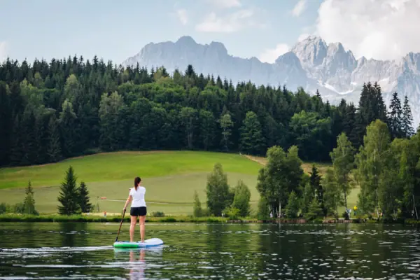 A woman on a paddleboard on a lake.