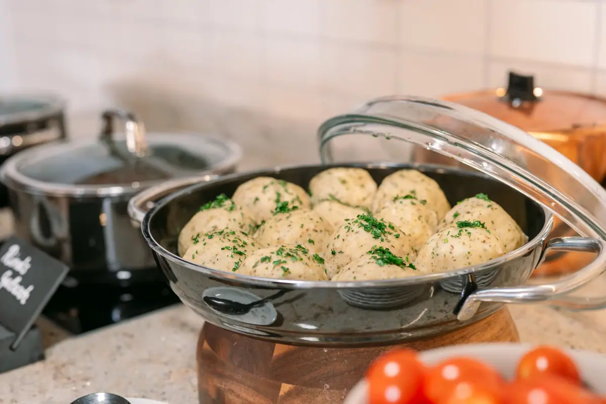 Pan with dumplings Bowl of food on a counter.