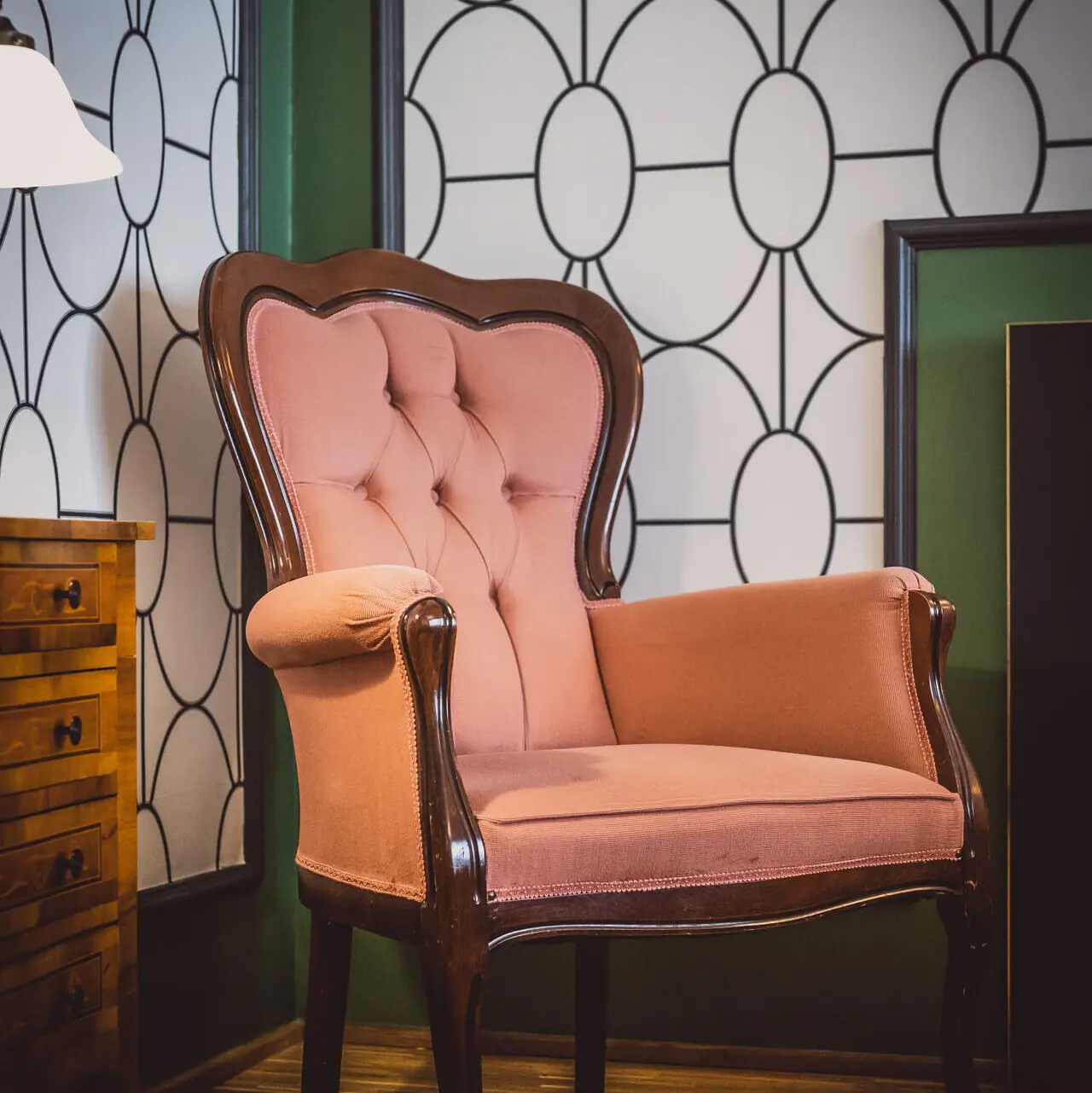 Armchair A pink armchair in a room.