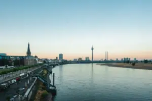 Düsseldorf Skyline River with a bridge and city skyline in the background.