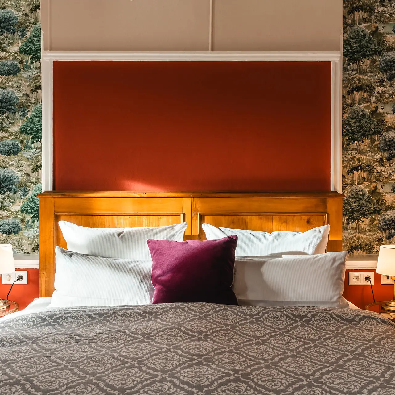 Bed in the Kaiser house A bed with a red and white cushion.