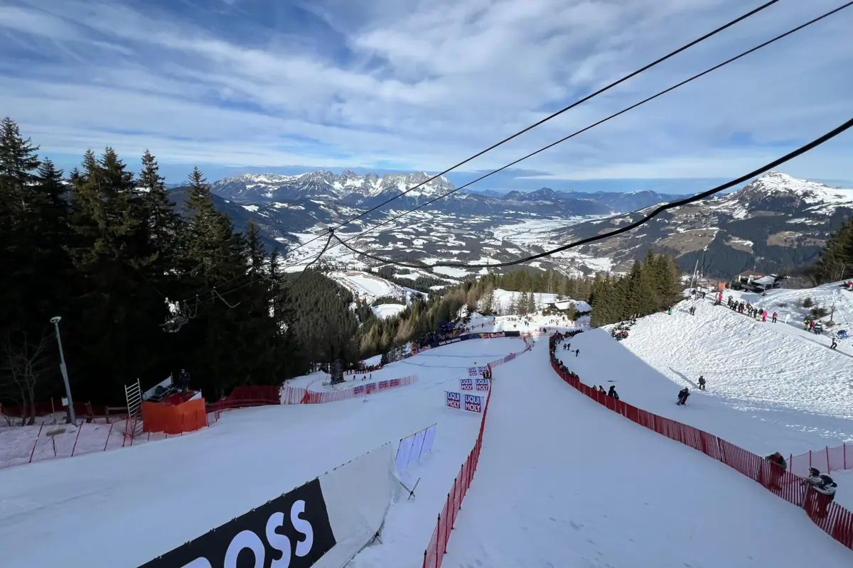 Snow-covered mountain with trees and ski lift.