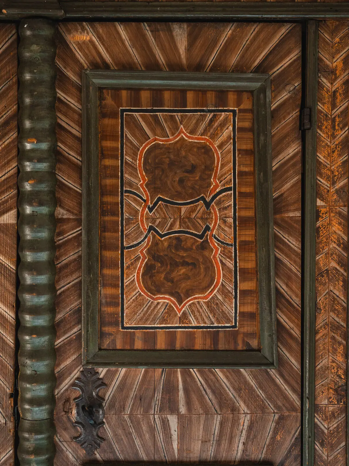 Door with wood decor Wooden door with artistic design and symmetrical patterns.