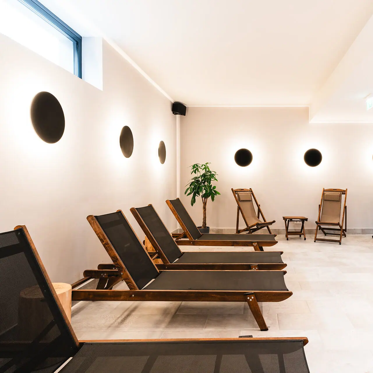 Spa loungers A room with chairs and a plant.
