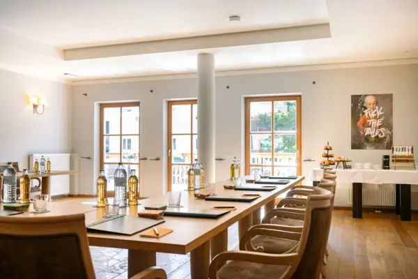 Meeting room at the HENRI Kitzbühel A room with a table and chairs.