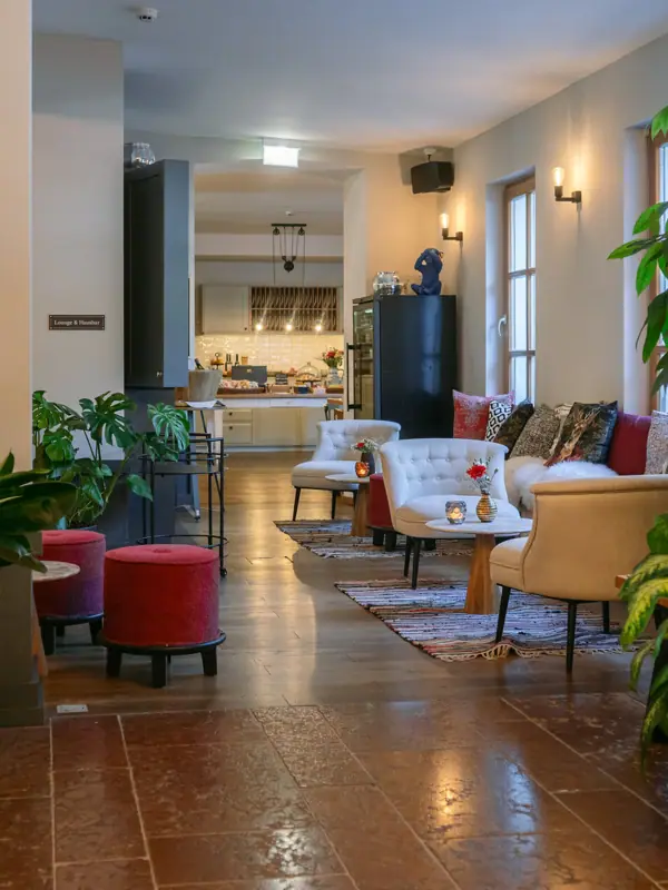 Lobby A room with a large plant and chairs.