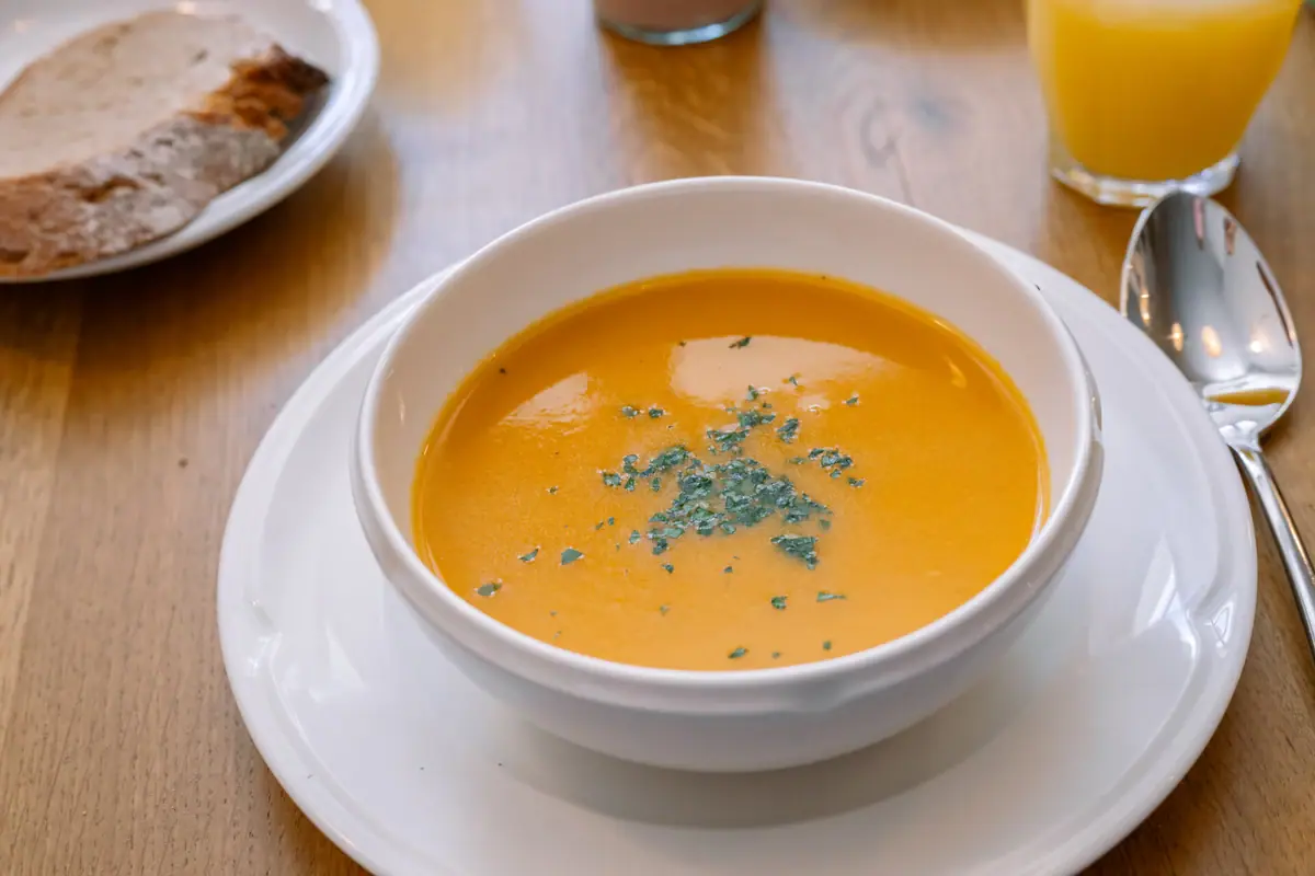 Soup A bowl of soup on a plate.