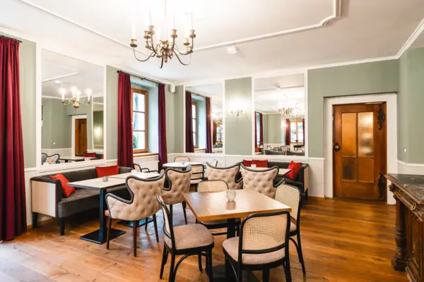 Hall of Mirrors at the HENRI Hotel Kitzbühel A room with tables and chairs.