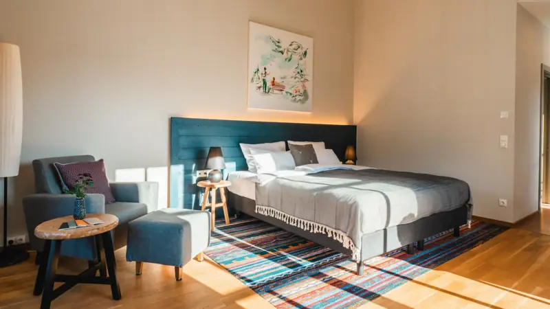 Rooms in Haus Ache Bedroom with bed and chair