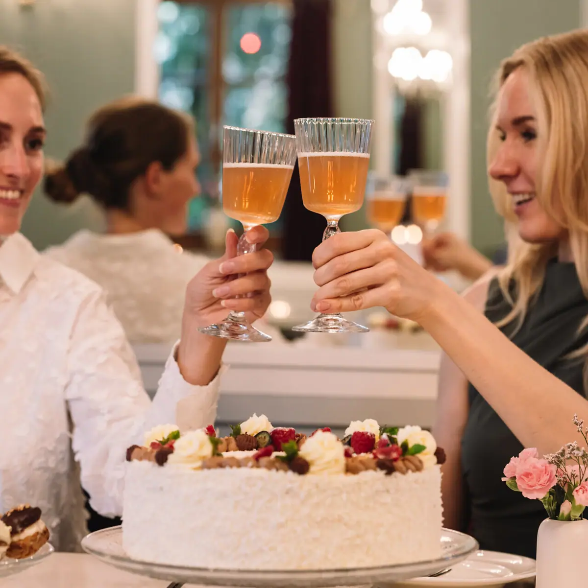 A group of women holding wine glasses.