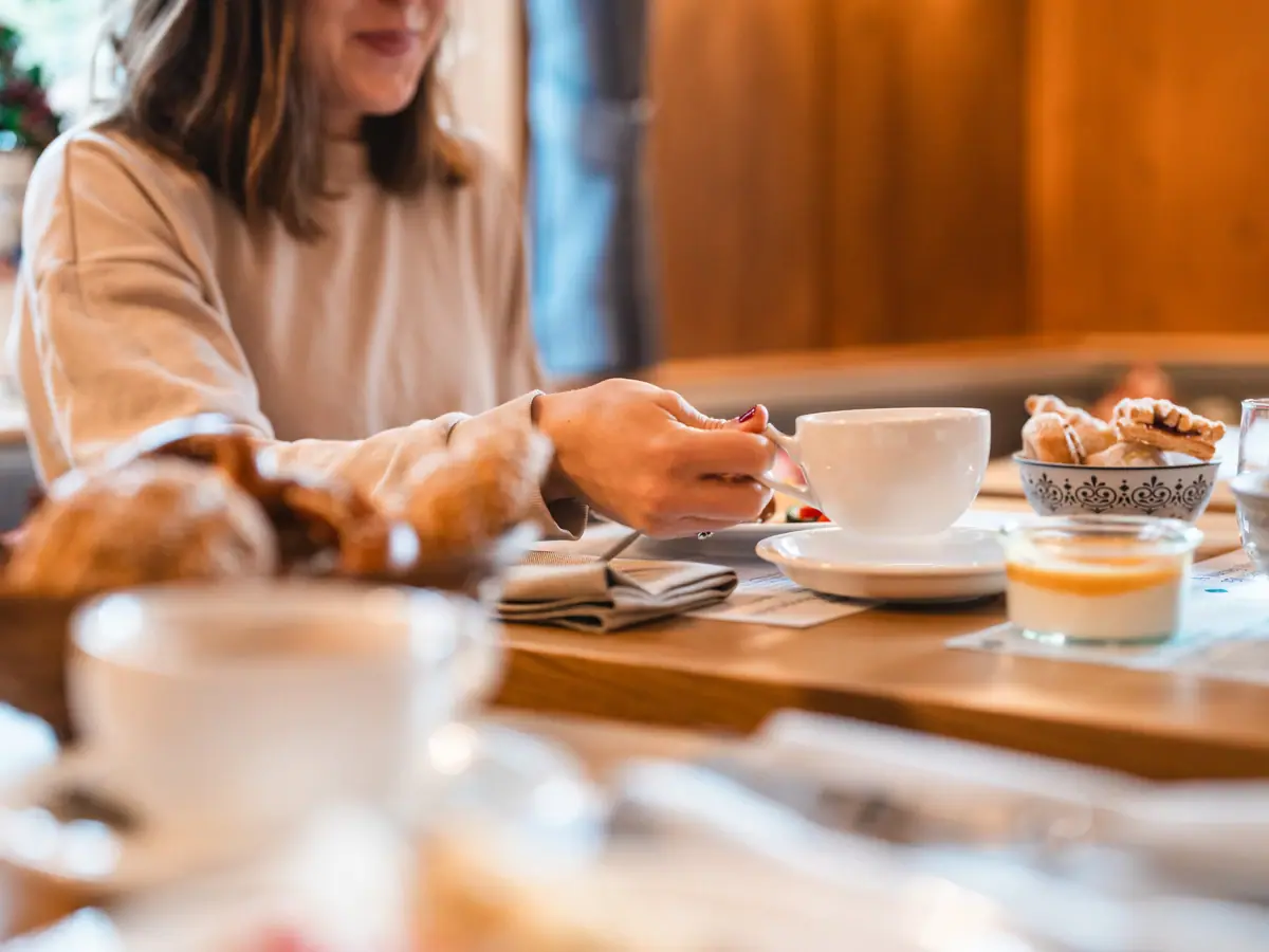 Table with breakfast A woman at the breakfast table