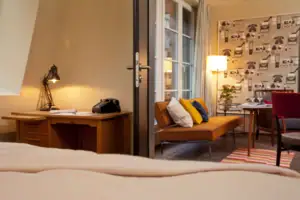 Review A room with a sofa and a desk.