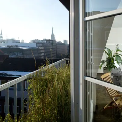 Balcony in the wellness area of the HENRI Hamburg View over the rooftops of Hamburg