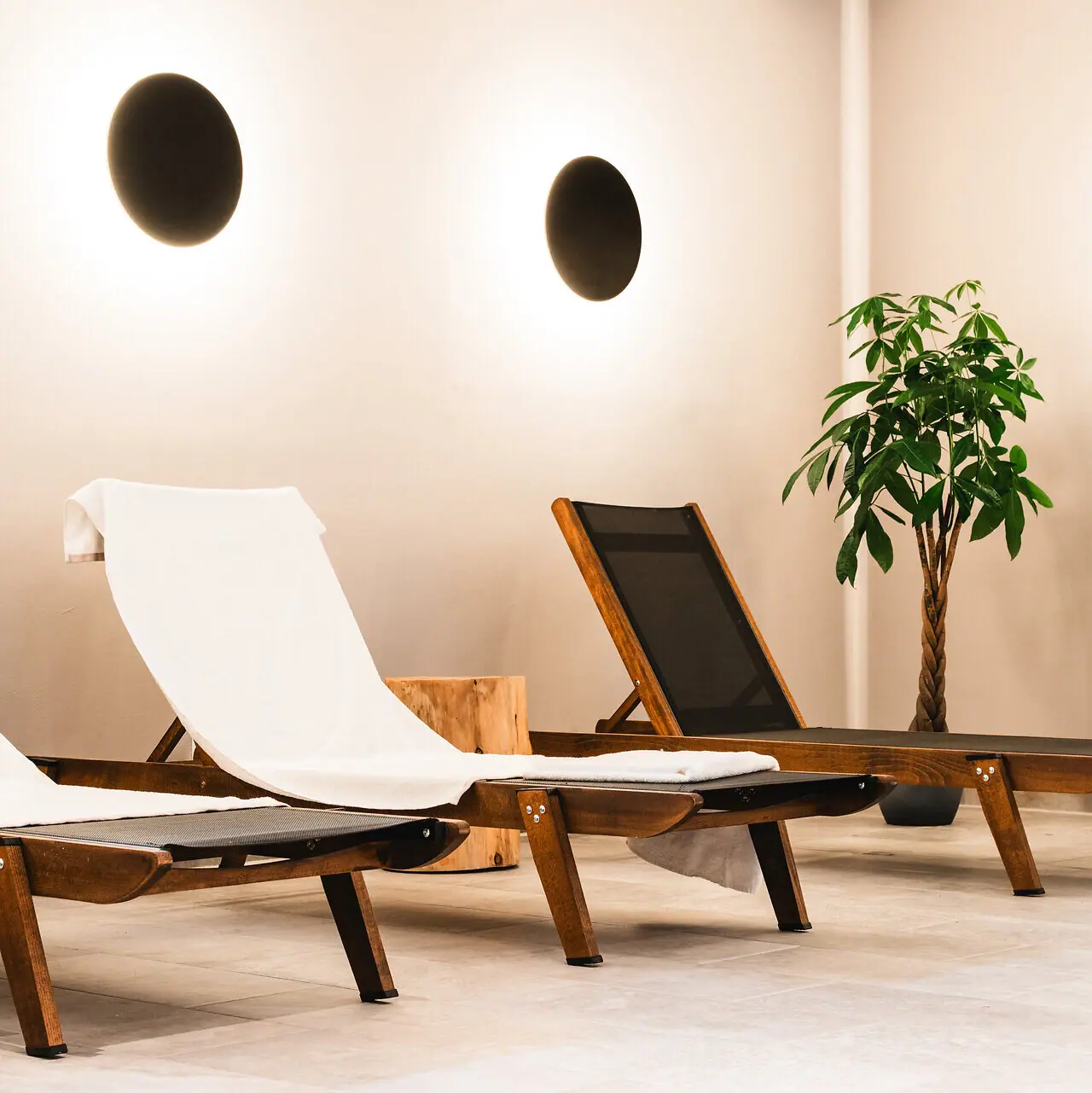 Deckchairs in the pool area A group of chairs in a room.