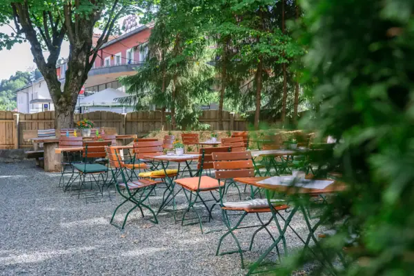 Beer garden at the HENRI Kitzbühel A group of tables and chairs outside.