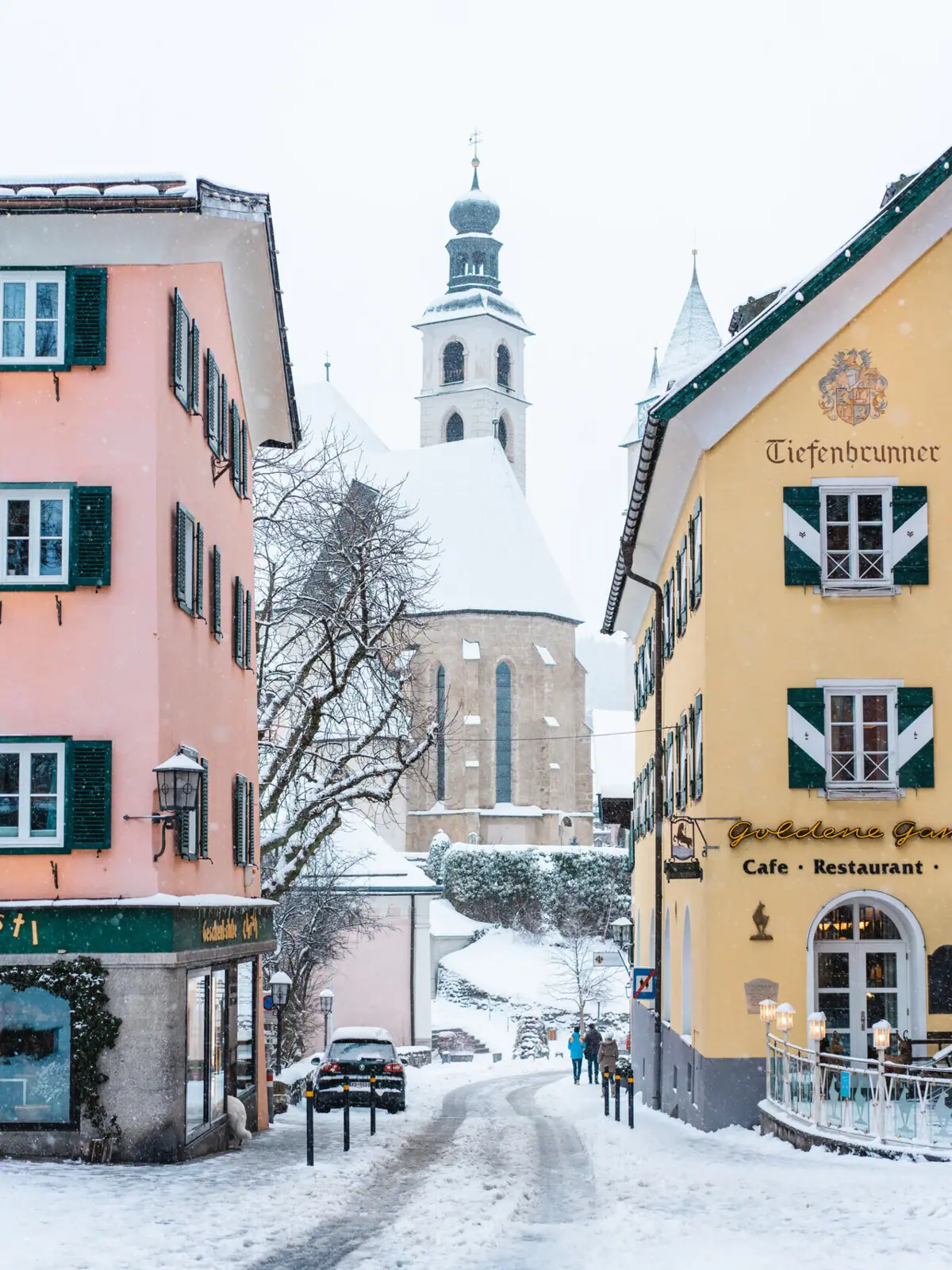 Old Town Kitzbühel A group of buildings with snow on the ground.