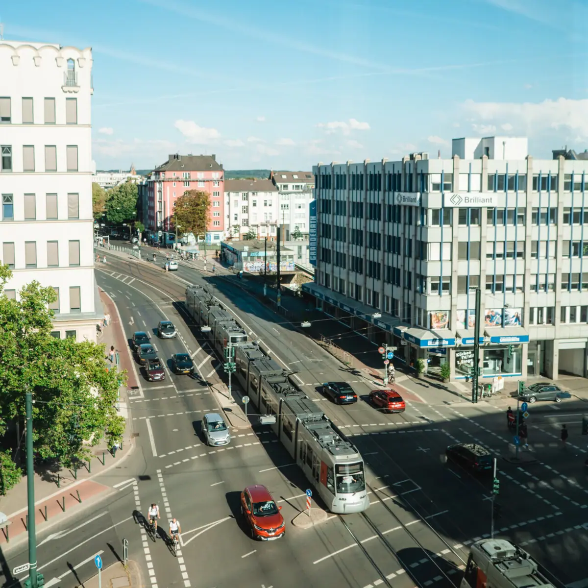 Düsseldorf Street with cars and buildings in the background.