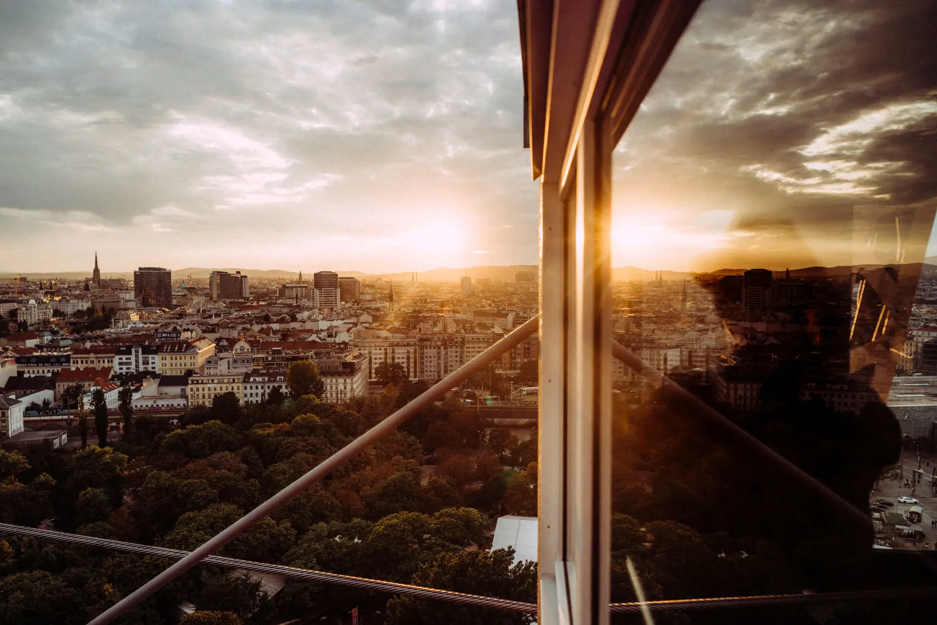 Vienna from the Prater View of a city through a window with clouds and sky in the background.