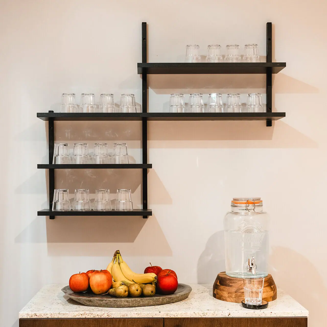 Water and fruit in the wellness area A fruit on a plate on a worktop.