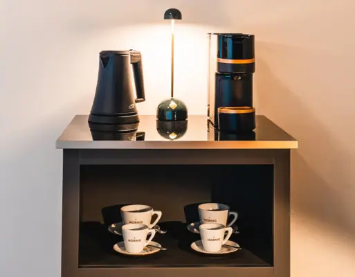 Coffee machine Coffee machine, kettle and cups on a shelf