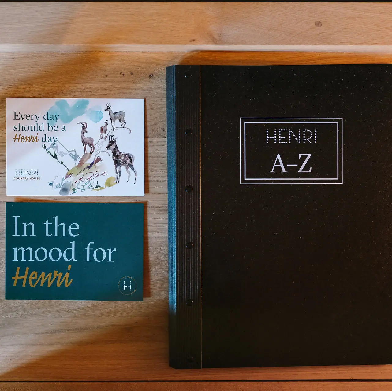 HENRI room details A book and a business card on a table.