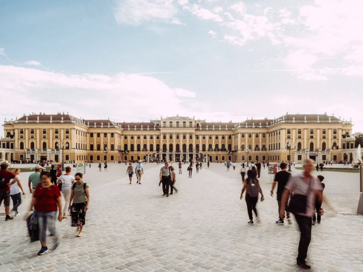 Schönbrunn Palace A group of people are walking in a courtyard.