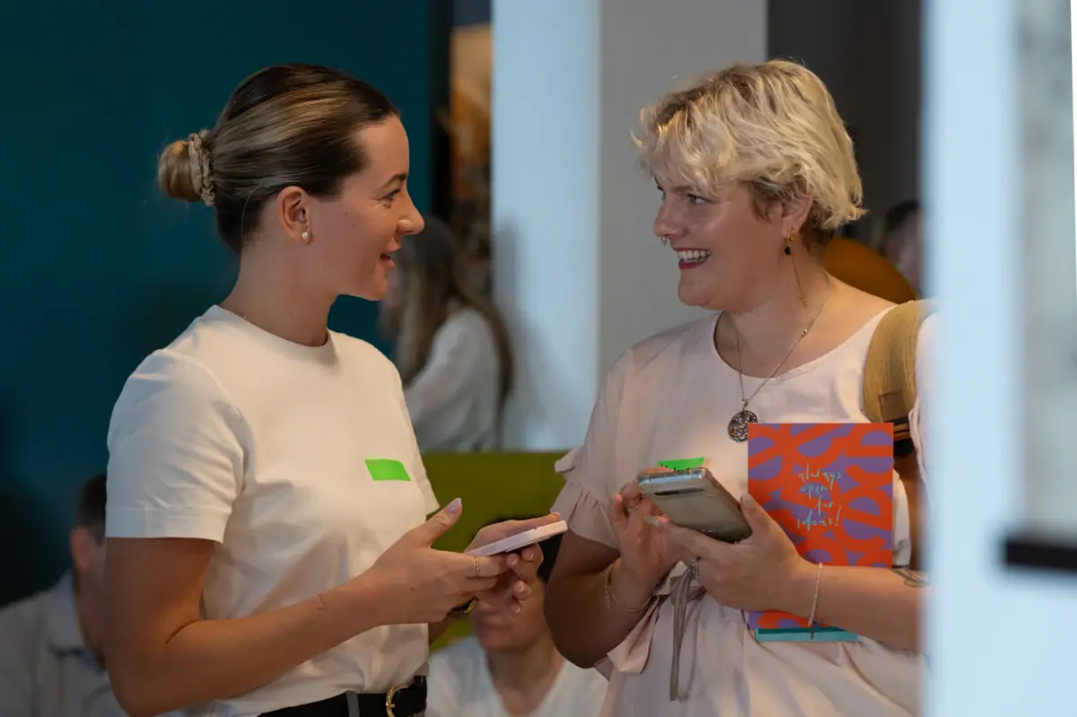2 Women networking A woman talks to another woman.