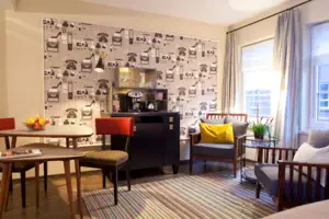 Living area A room with a coffee machine and chairs.