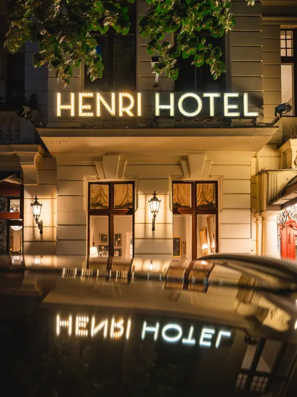 HENRI Hotel Berlin entrance by night A building with an illuminated façade.