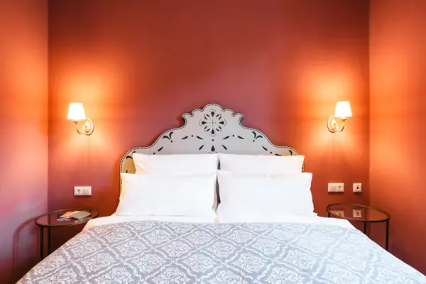 Bedroom Bed with pillow and wall lamp