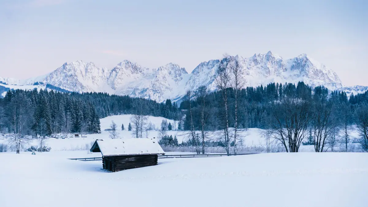 A hut in a snow-covered field.