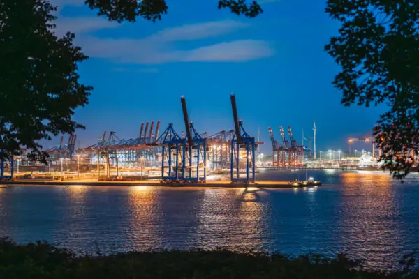 Port of Hamburg Large harbour with cranes and lights at night.