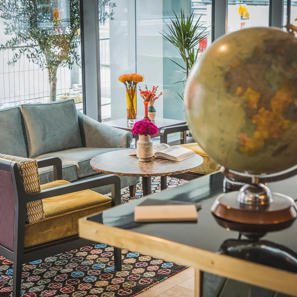 HENRI Bar A room with a globe and a couch.