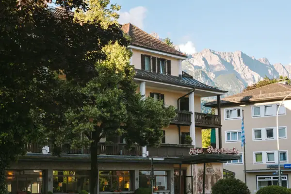 HENRI Garmisch-Partenkirchen Exterior view A building with trees and mountains in the background.