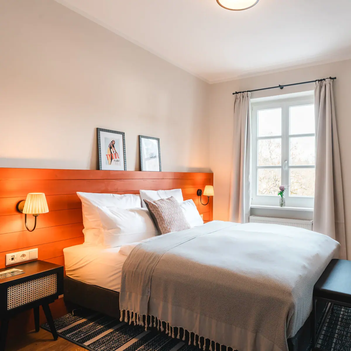 Bed A bed with a wooden headboard and a lamp.