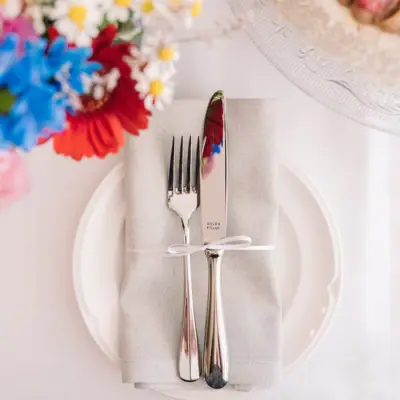Cutlery beautifully draped on a plate Fork and knife on a napkin with flowers