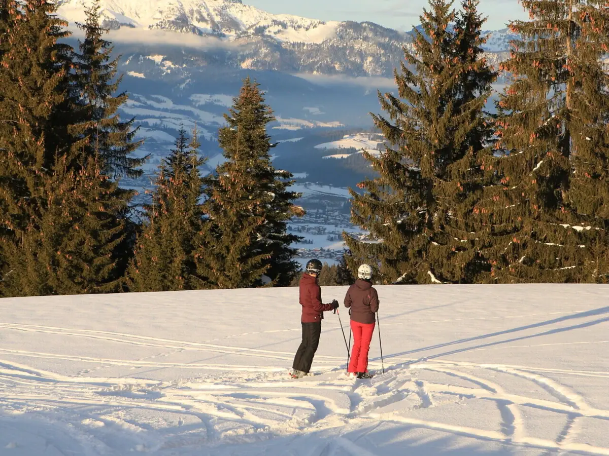 Two people skiing in the snow.