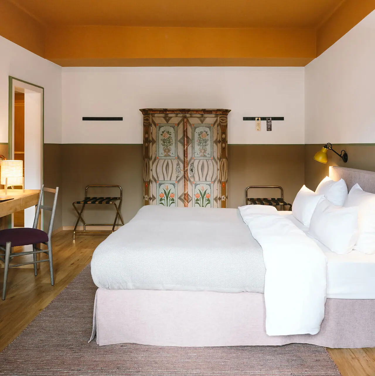 Hotel rooms at the HENRI Garmisch-Partenkirchen A bed in a hotel room with a stylish interior design.