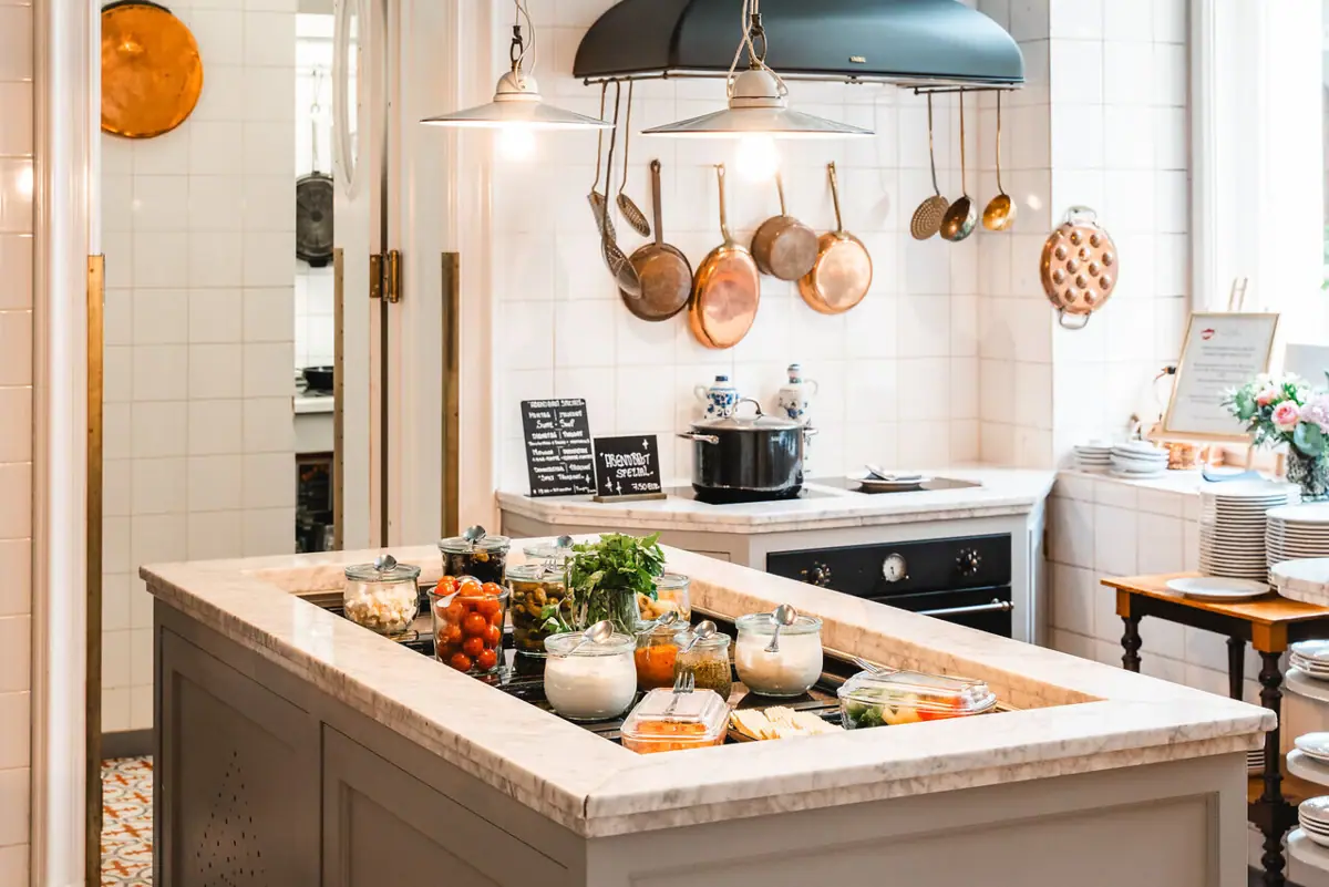 HENRI Evening meal A kitchen with a large island on which food is placed.