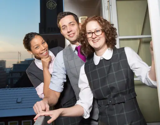 HENRI employees A group of people are standing in front of a window.