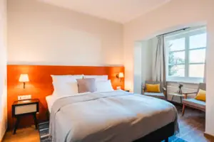 Bed Bed with white cover and orange headboard