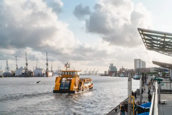 Ferry A boat on the water under a cloudy sky.