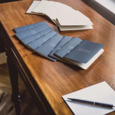 HENRI Berlin notepads A group of black and white papers on a table